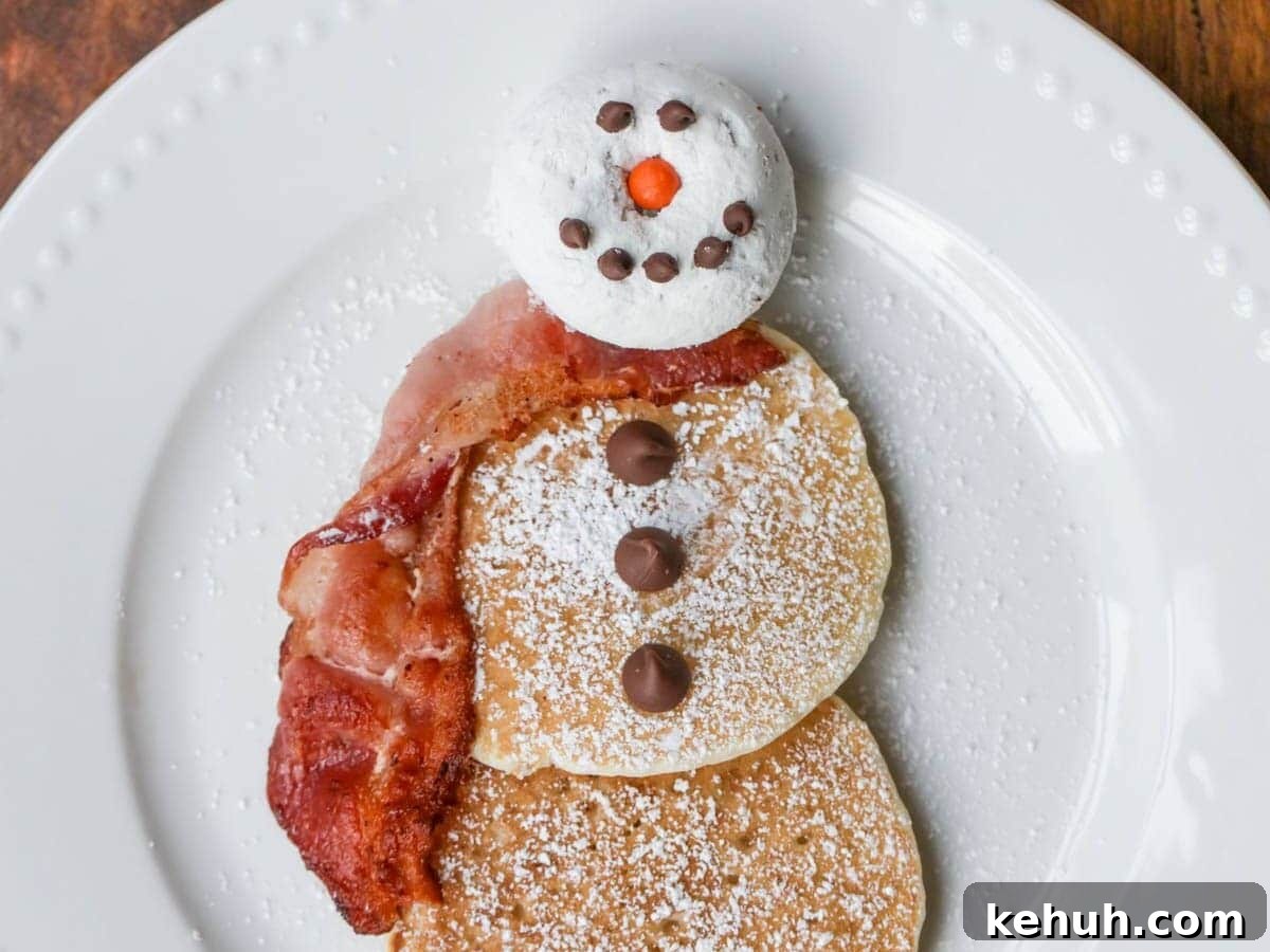 Snowman pancakes on white dish.