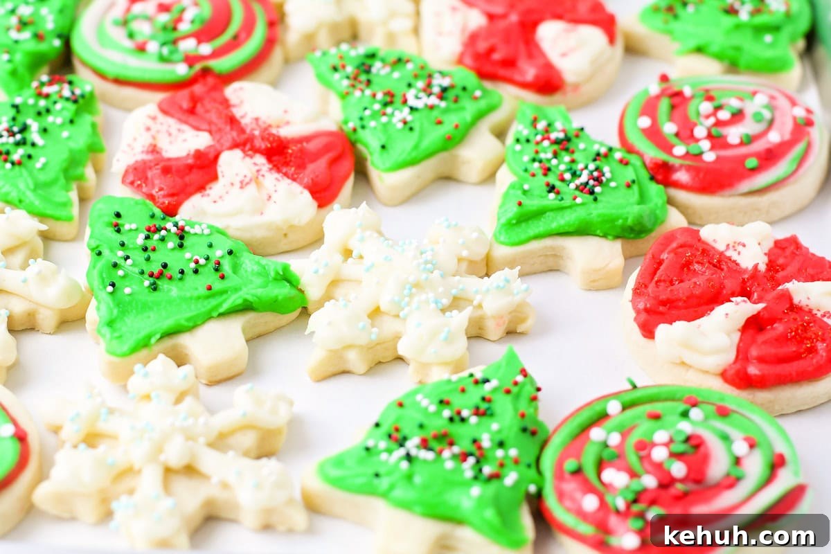 Multiple Christmas sugar cookies on parchment paper.