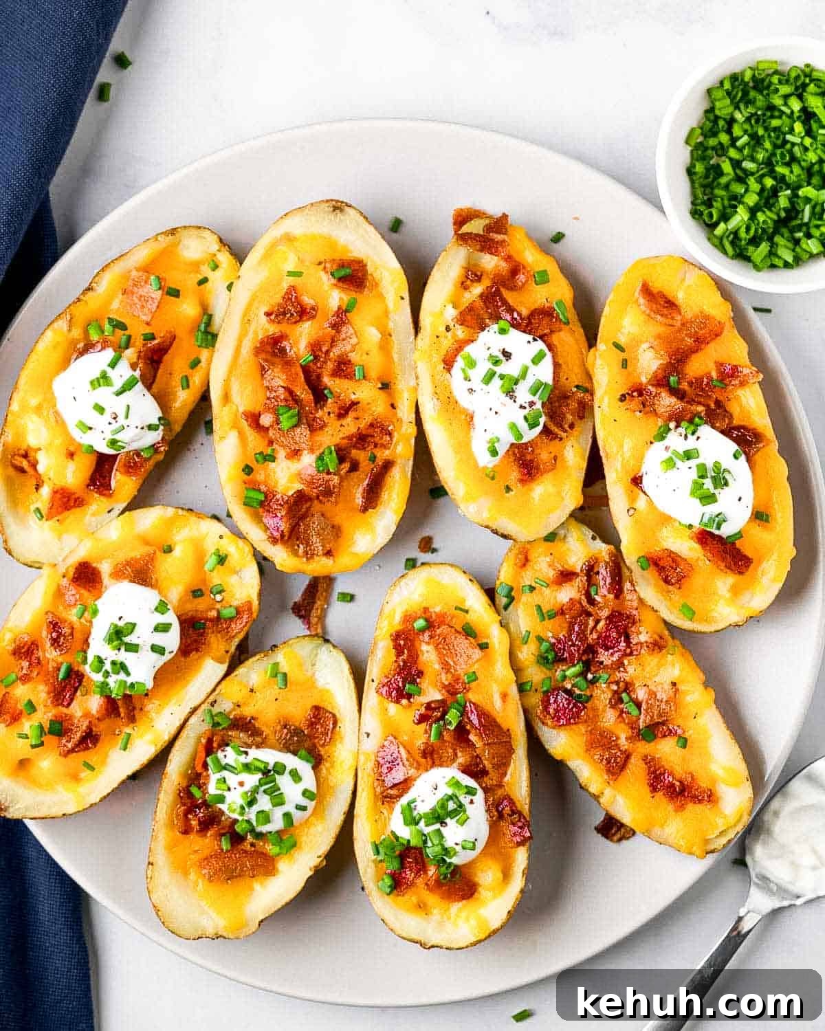 Crispy Air Fryer Potato Skins Filled with Cheesy Bacon 10 plate of 8 air fryer potato skins and toppings.
