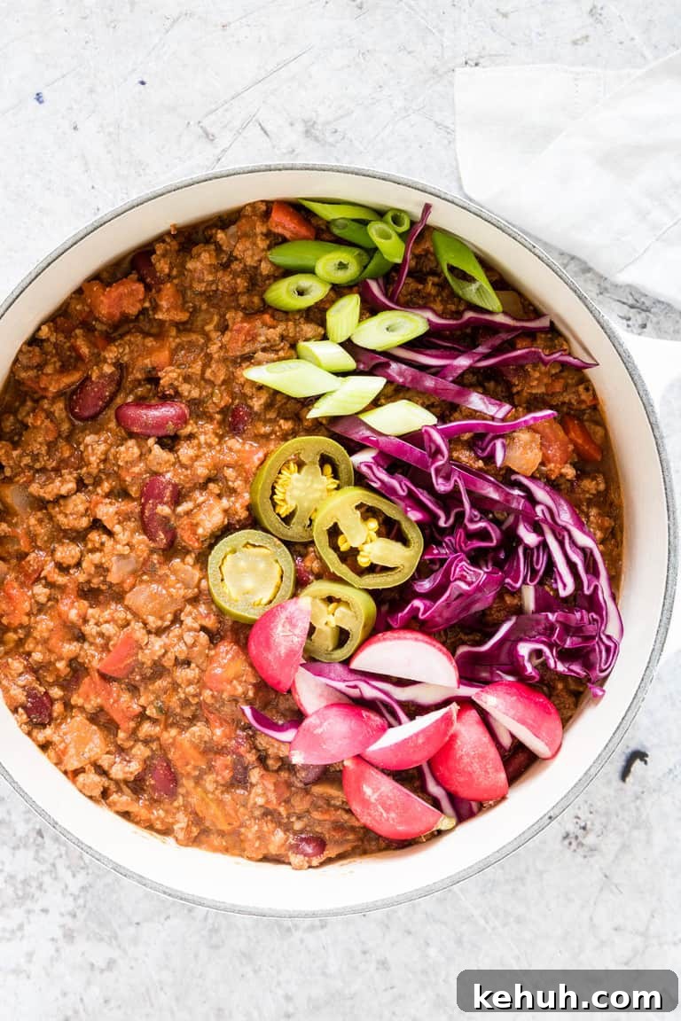 Instant Pot Soup Recipes You’ll Actually Love 33 venison chili in a white pot with garnishes