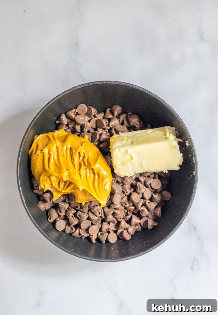 Autumn Puppy Chow: Cozy No-Bake Snack Mix Recipe 5 Chocolate chips, peanut butter, and butter in a black bowl