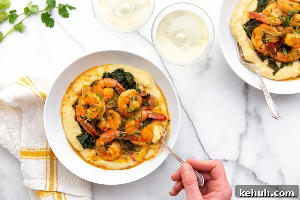 Coconut Sriracha Shrimp with Garlicky Kale Bowl 5 Coconut sriracha shrimp and kale over grits in serving bowls, with hand taking a bite with a fork