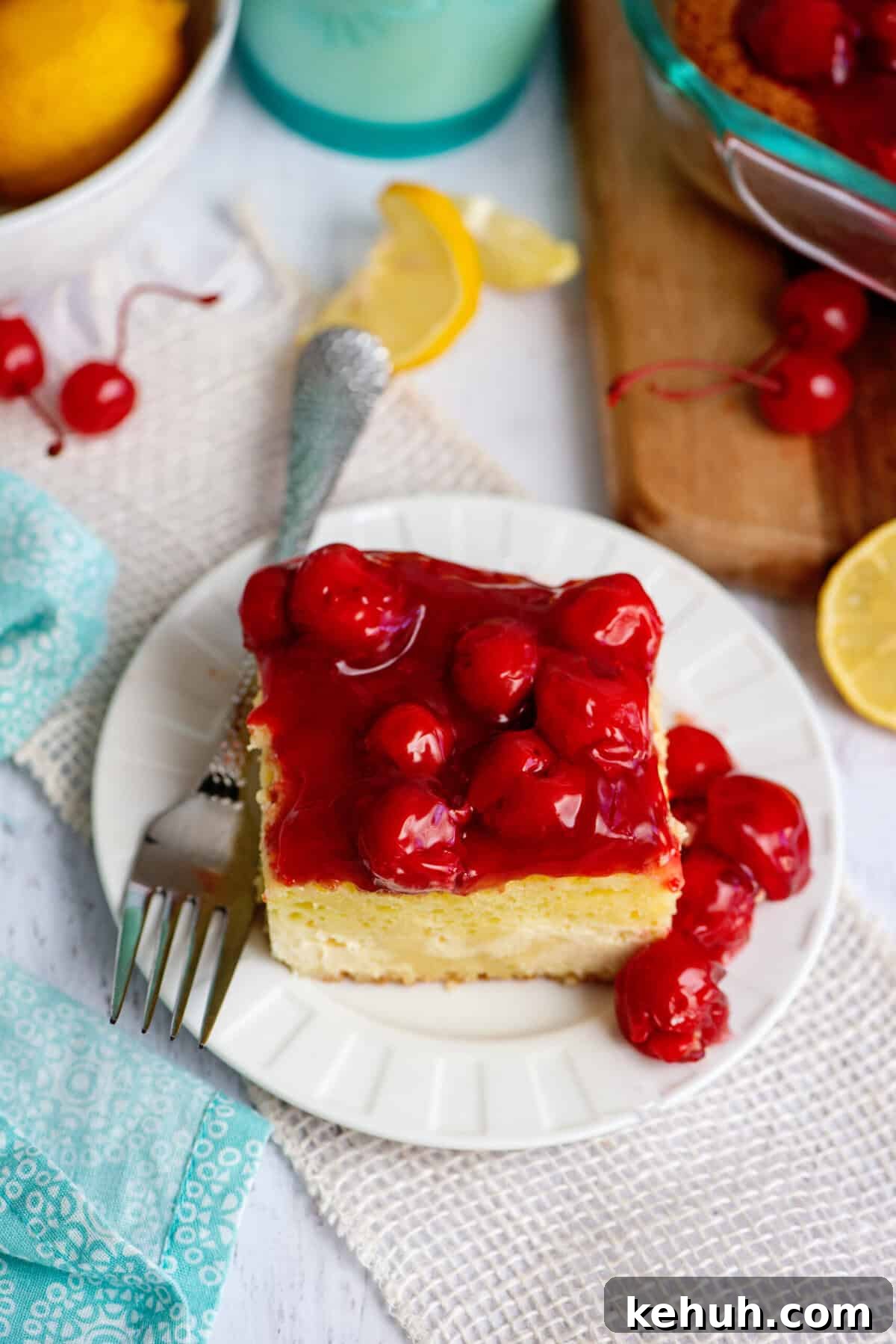 A plate with one serving of lemon cherry cheesecake