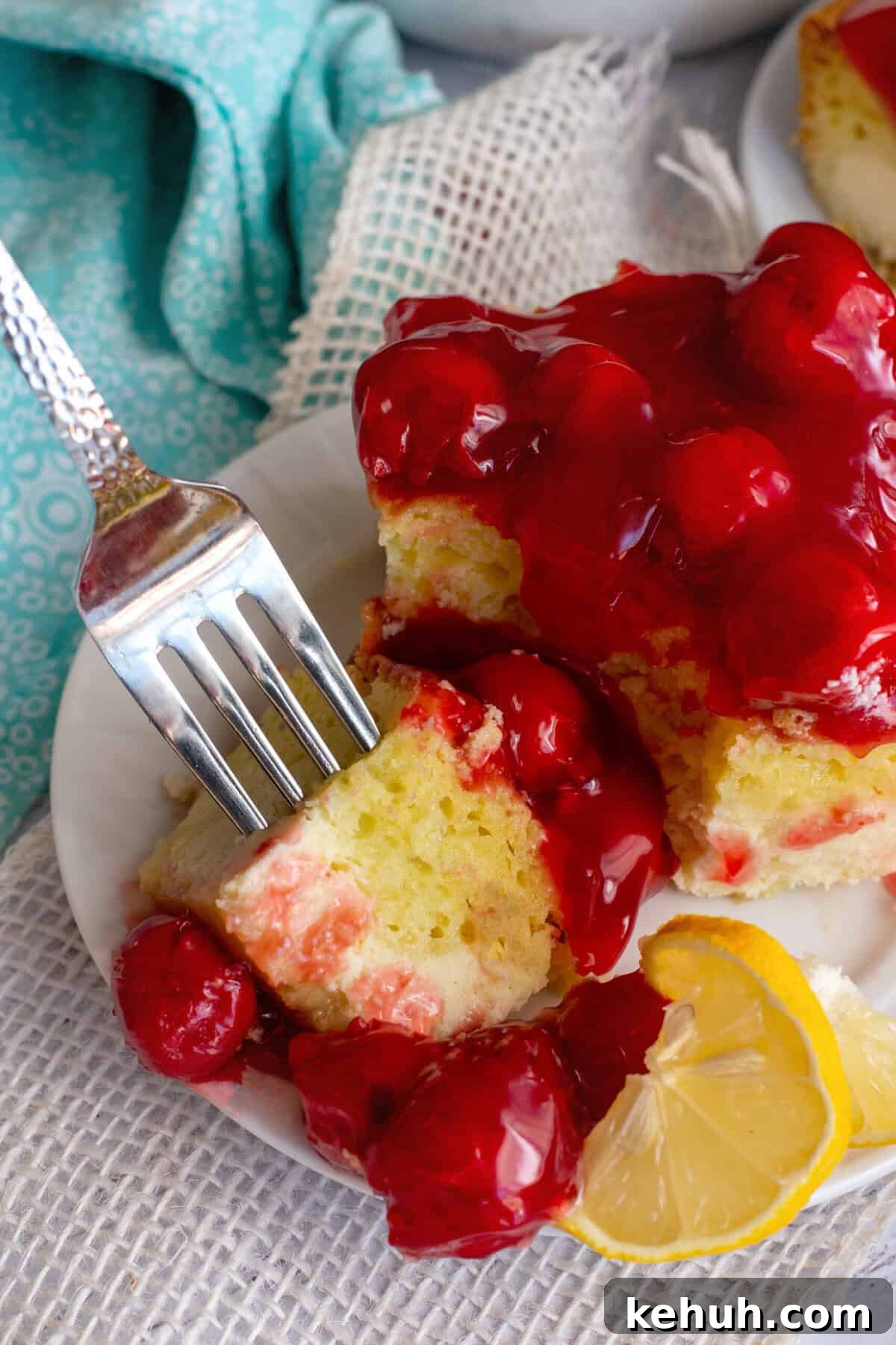 Taking a piece of lemon cherry cheesecake with a fork