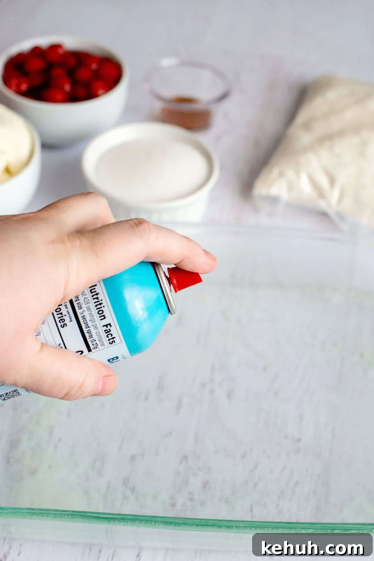 Spraying a baking pan with non-stick spray