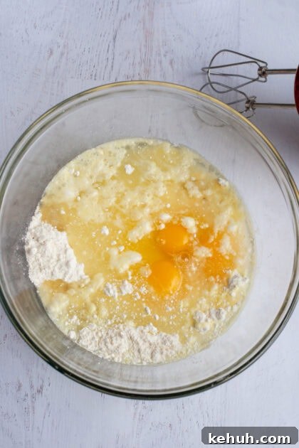 ricotta, eggs, sugar, and vanilla being mixed in a bowl