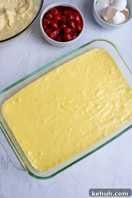 A smooth cake batter layer in a baking pan