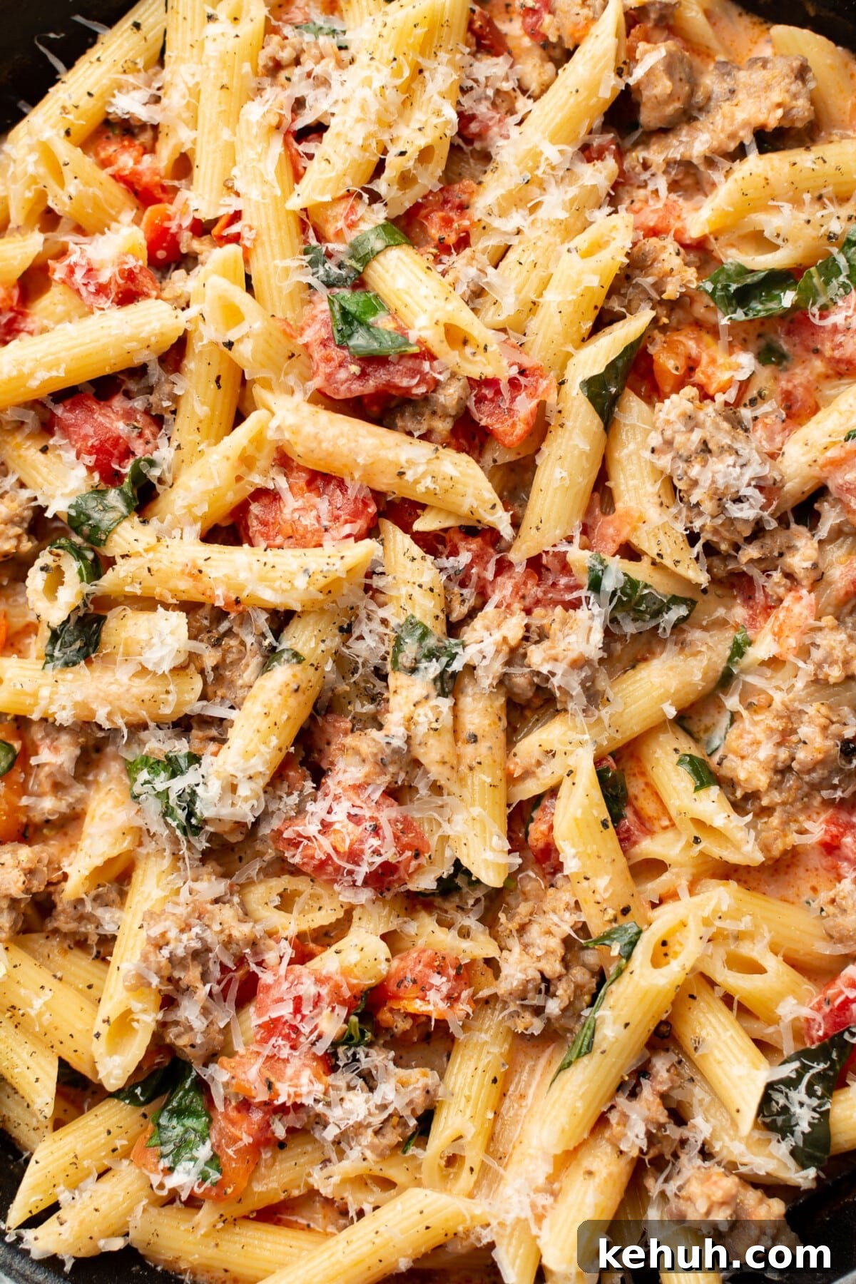 closeup of a skillet with spicy italian sausage pasta