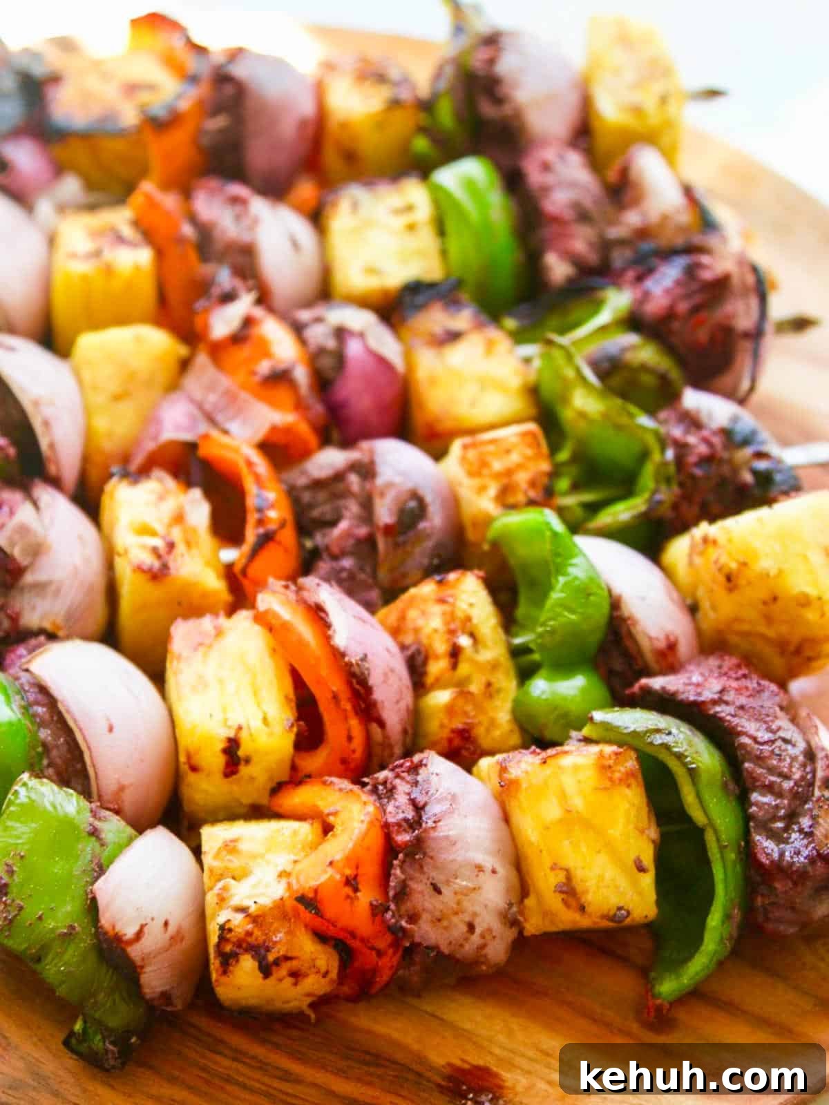 Grilled skewer shish kabobs made with beef, bell pepper, pineapple, and onion.