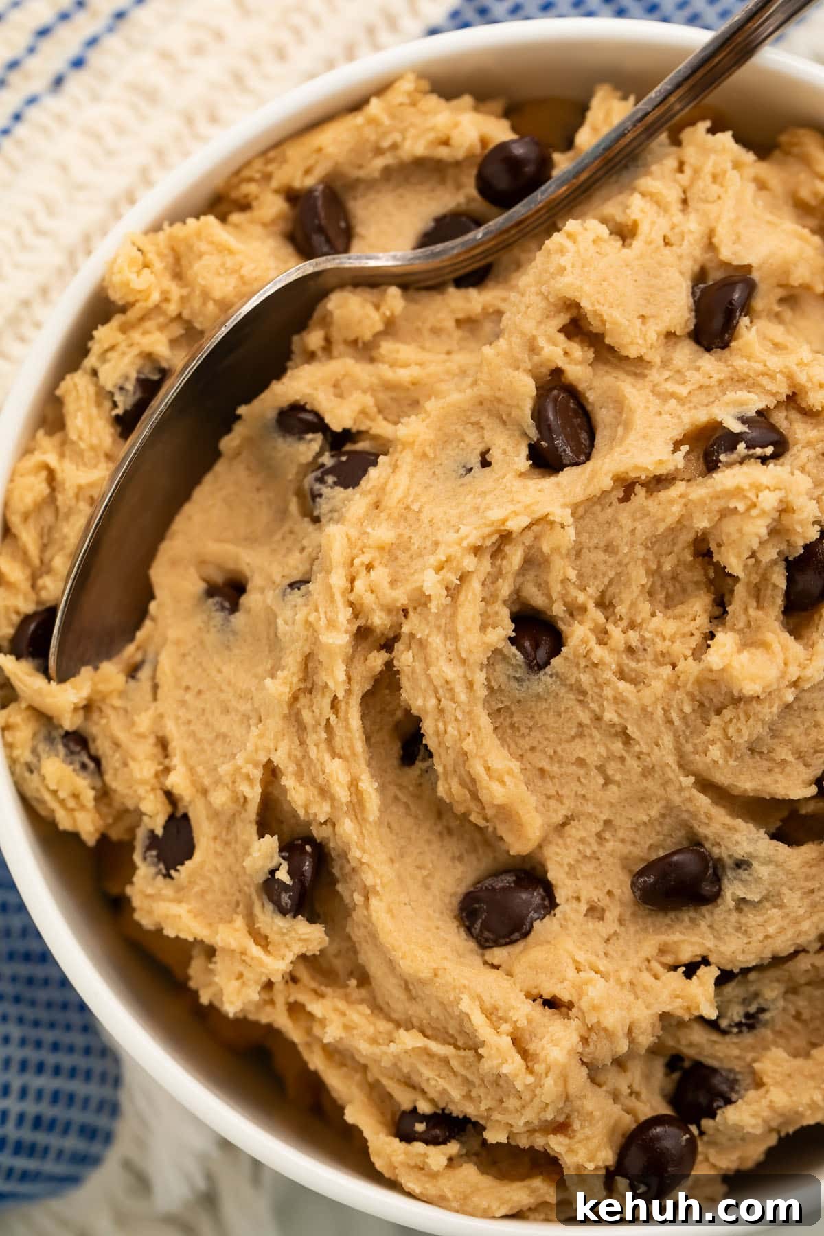 Vegan Cookie Dough Recipes: Safe-to-Eat & No-Bake Options 2 Close-up of a bowl of edible vegan cookie dough with a spoon resting in the dough.