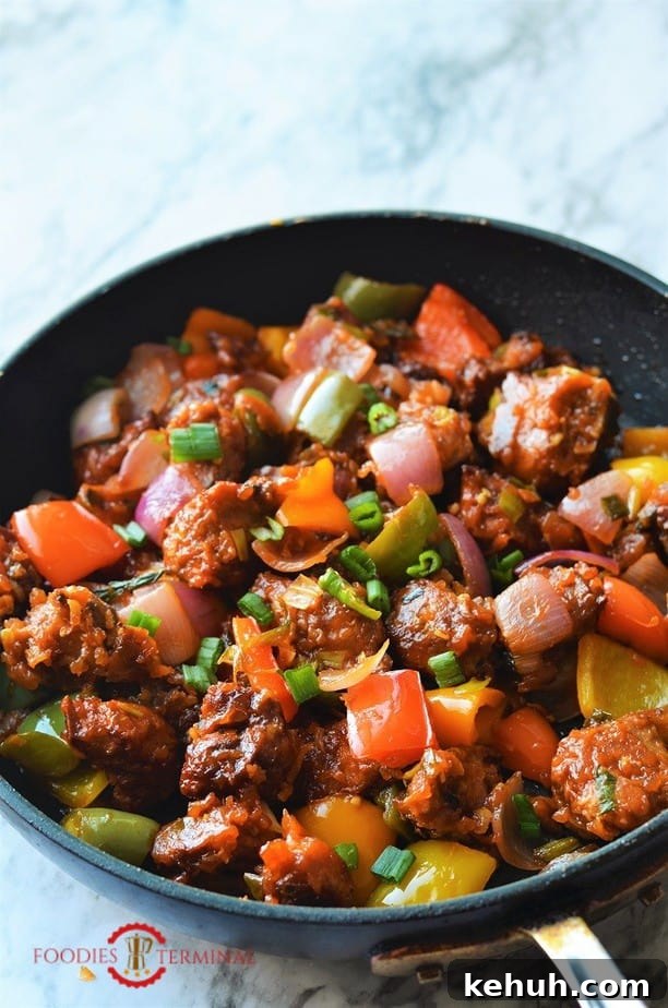 Chilli Chicken tossed in sauces in skillet