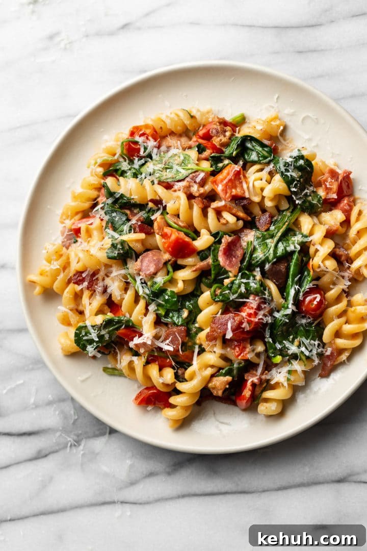 BLT pasta on a beige plate