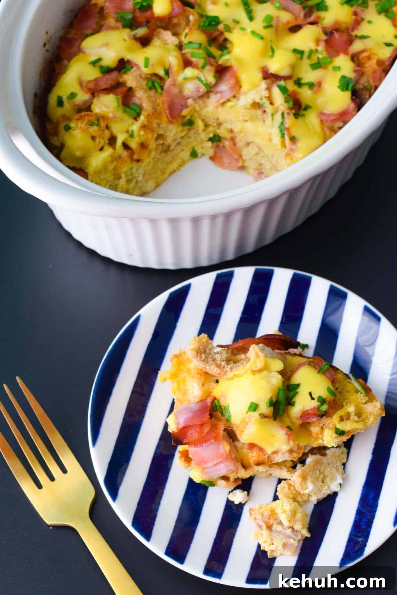 Overnight Eggs Benedict Casserole served in blue and white striped plate overhead shot