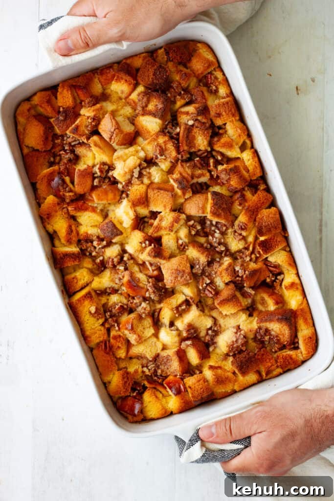 Brioche French Toast Casserole Recipe for Brunch and Holidays 11 Hands with towels carrying a hot out of the oven brioche French toast casserole.