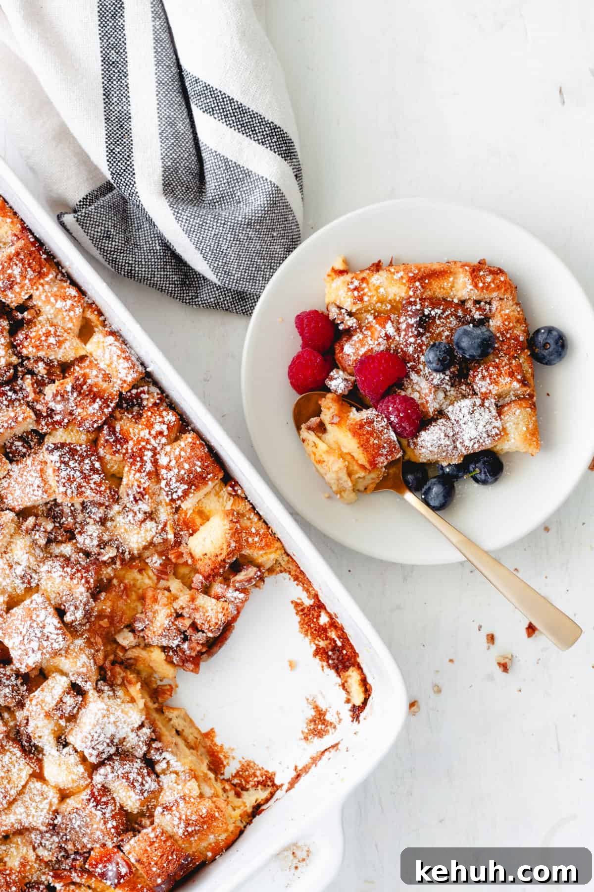 Brioche French Toast Casserole Recipe for Brunch and Holidays 3 A piece of brioche French toast casserole on a small plate with the casserole dish in the background.