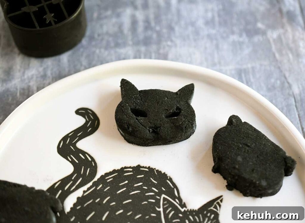 Cat and Cauldron black vegan gnocchi on a Halloween black cat plate.