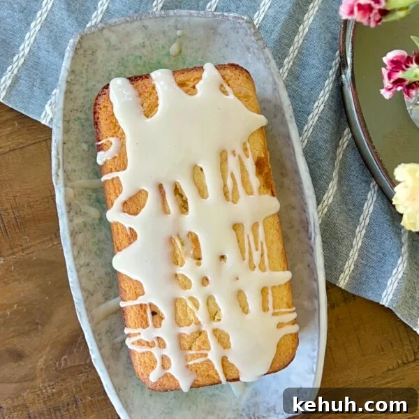 Sourdough Peach Crumb Pie Recipe with Flaky Rustic Crust 17 Sourdough discard loaf cake topped with a thick lemon glaze on a serving plate.