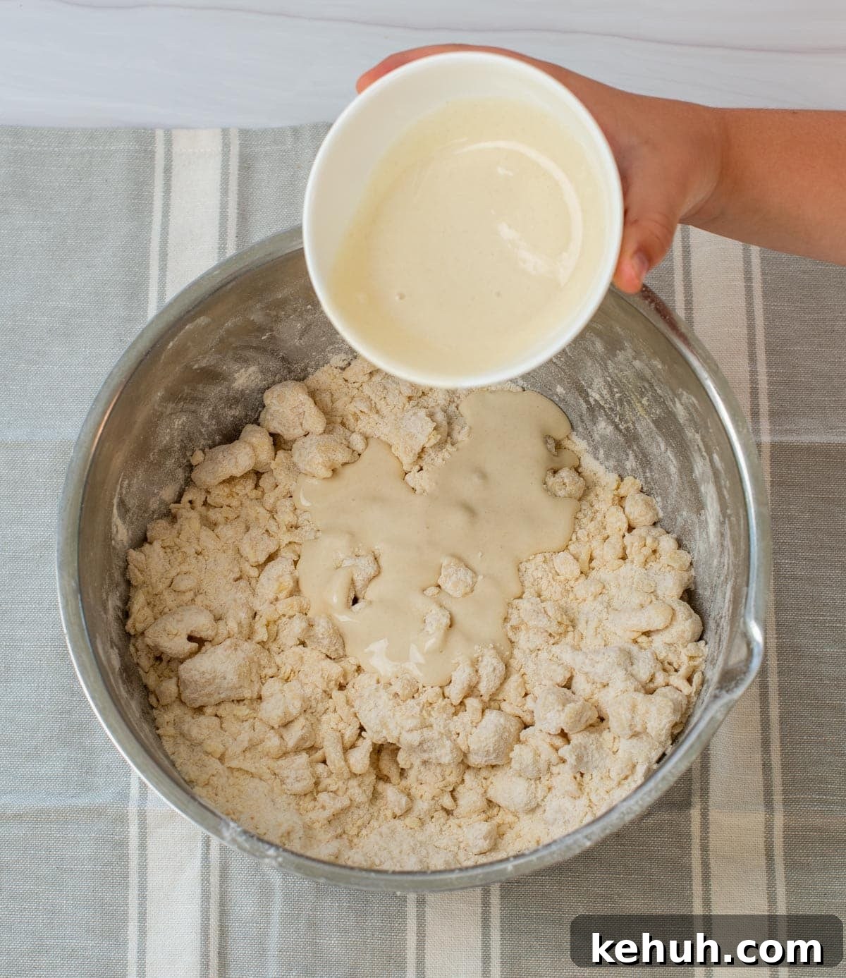 Sourdough Peach Crumb Pie Recipe with Flaky Rustic Crust 5 Sourdough discard is poured into a mixing bowl with flour and butter.