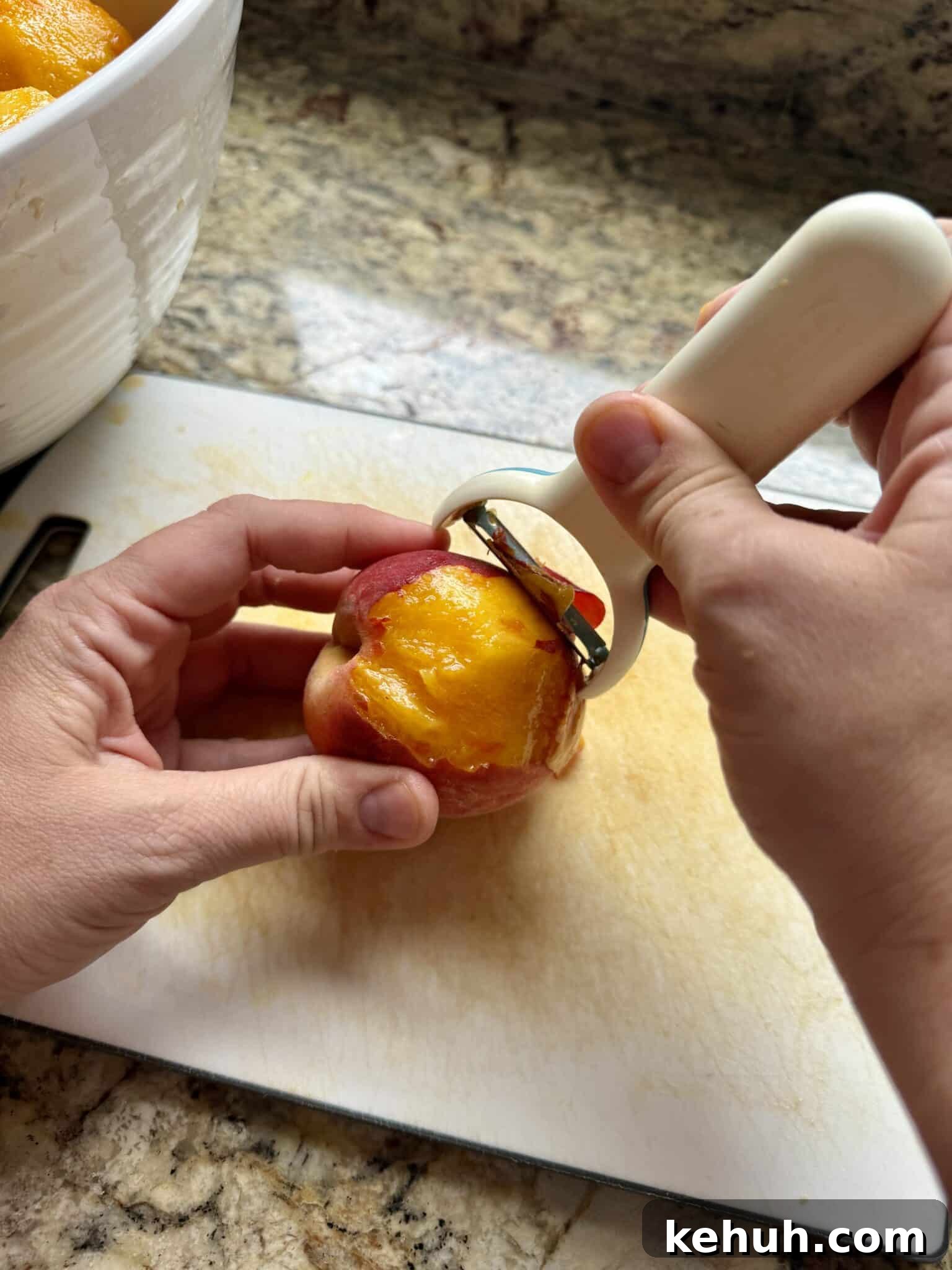 Sourdough Peach Crumb Pie Recipe with Flaky Rustic Crust 7 Hands peel a peach on a cutting board.