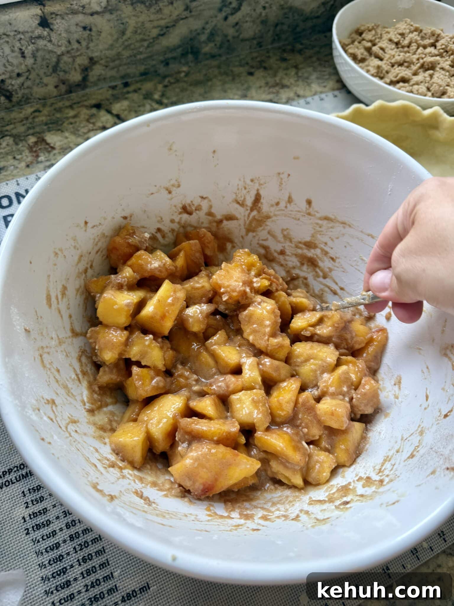 Sourdough Peach Crumb Pie Recipe with Flaky Rustic Crust 8 A mixing bowl contains peach chunks and filling ingredients.