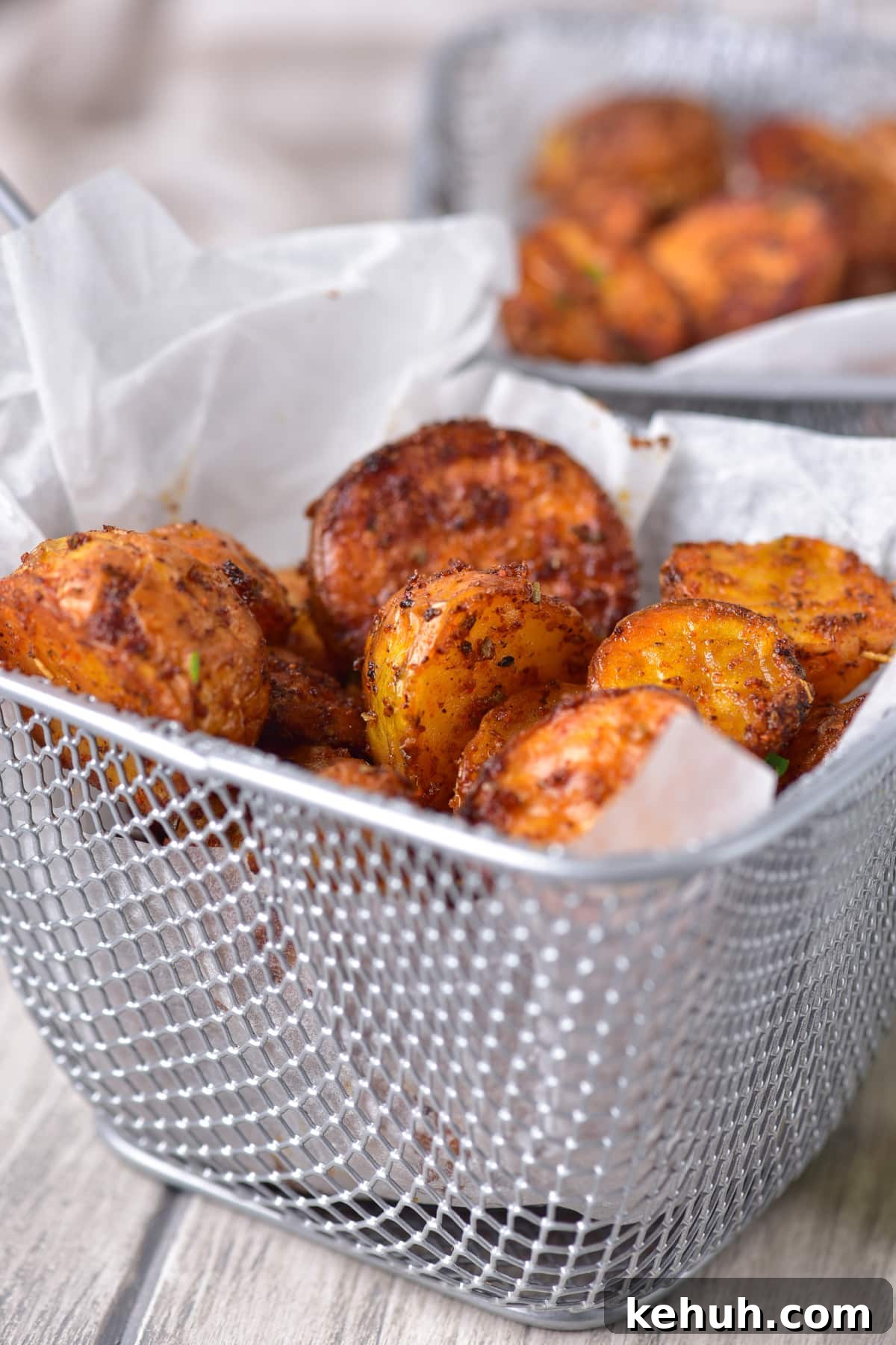 Crispy Air Fryer Baby Potatoes Recipe for Perfectly Roasted Bites 6 garlic baby potatoes in wire baskets that have been air fried