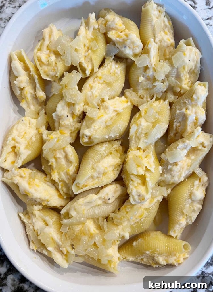 Pierogi-Stuffed Shells with Creamy Potato & Cheddar Filling 5 jumbo pasta shells with mashed potato filling and sauteed onions in casserole dish