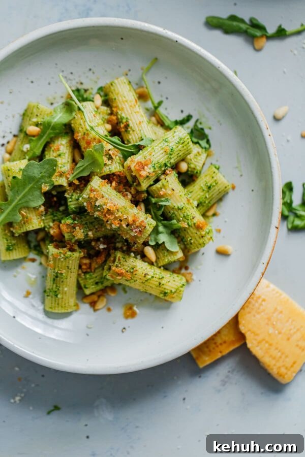 EASY Arugula Pesto Pasta - an easy twist on basil pesto made with baby arugula! Bright, peppery in flavor, and affordable to make, this arugula pesto pasta is a year-round favorite. Arugula Pesto Pasta with Garlicky Breadcrumbs on Plate