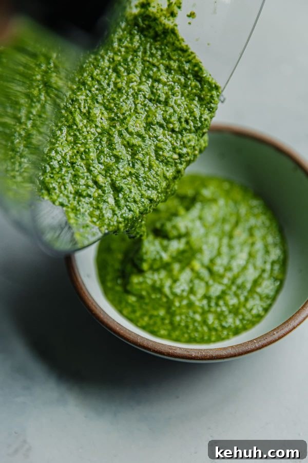 Arugula Pesto Being Poured into Bowl