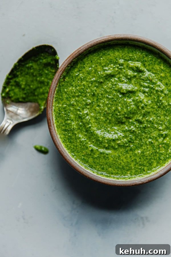 EASY Arugula Pesto Pasta - an easy twist on basil pesto made with baby arugula! Homemade Arugula Pesto in Bowl with Spoon