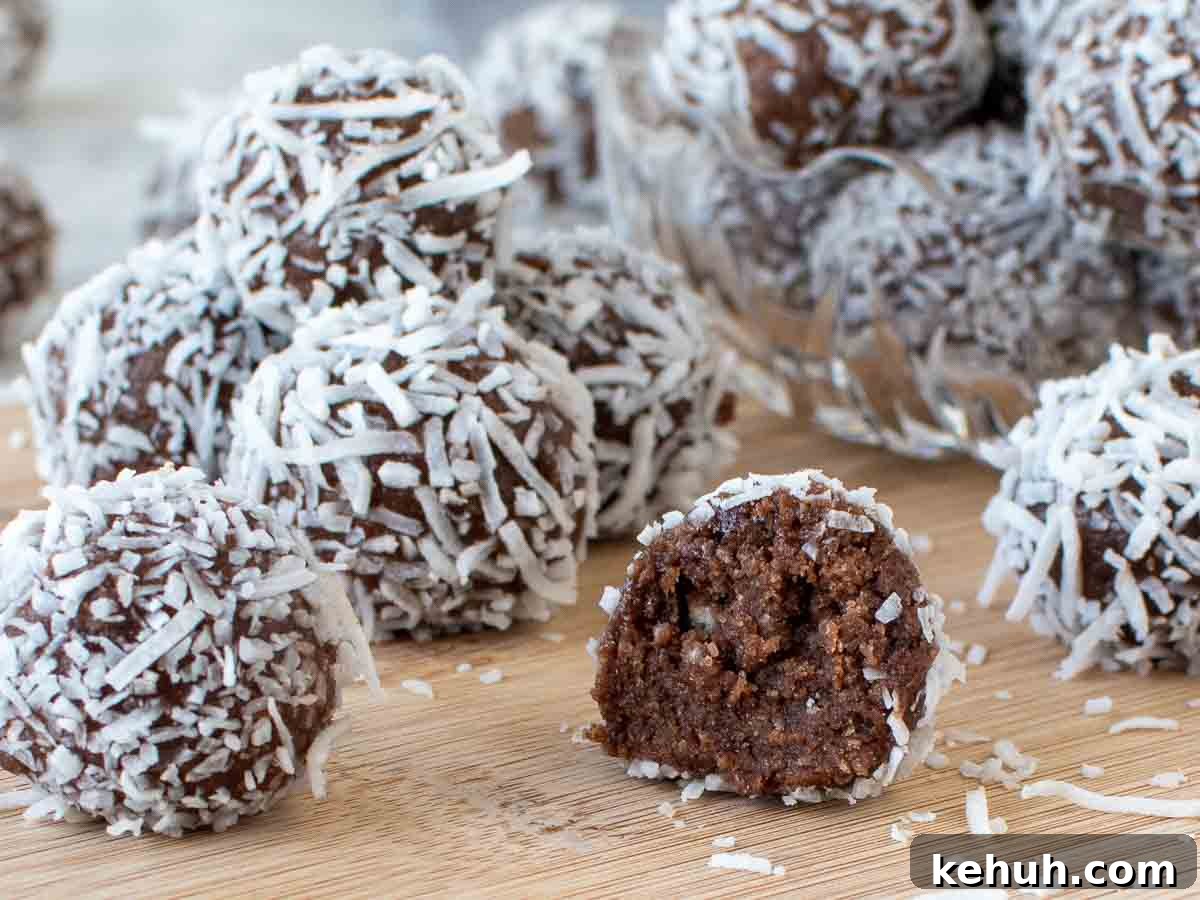 Close up of coconut coated chocolate balls including one cut in half.