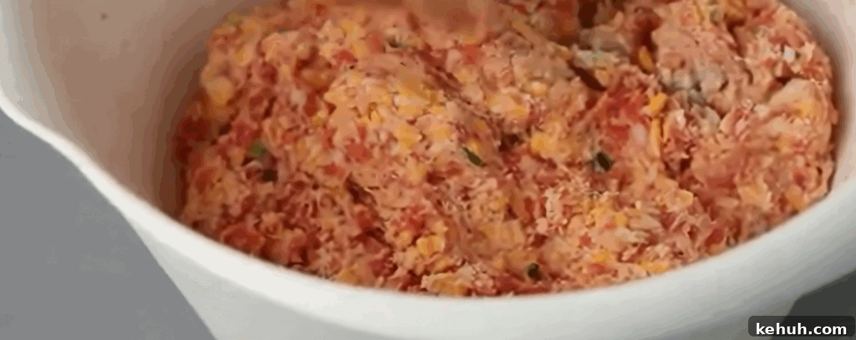 All the ingredients to make sausage balls in a white bowl