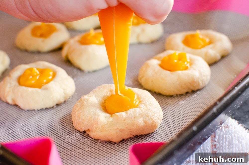 Thumbprint Cookies with Jam, Curd, or Chocolate Filling 17 Piping the passion fruit curd into thumbprint cookies
