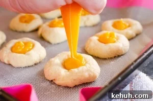 Thumbprint Cookies with Jam, Curd, or Chocolate Filling 9 Piping the passion fruit curd into our passion fruit thumbprint cookies