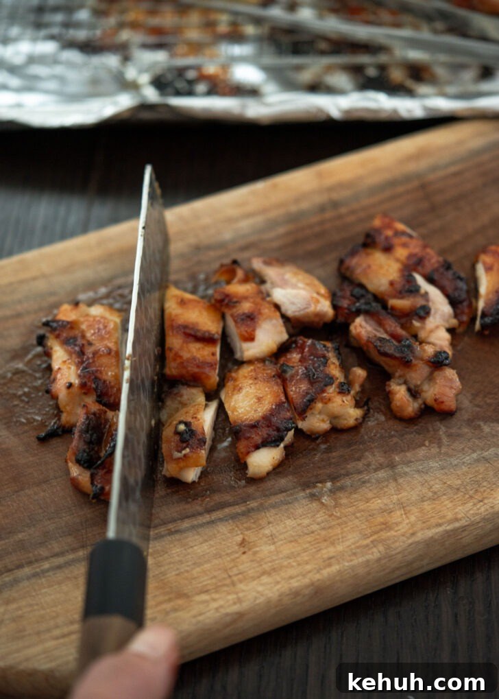 Slicing miso chicken into bite-sized pieces