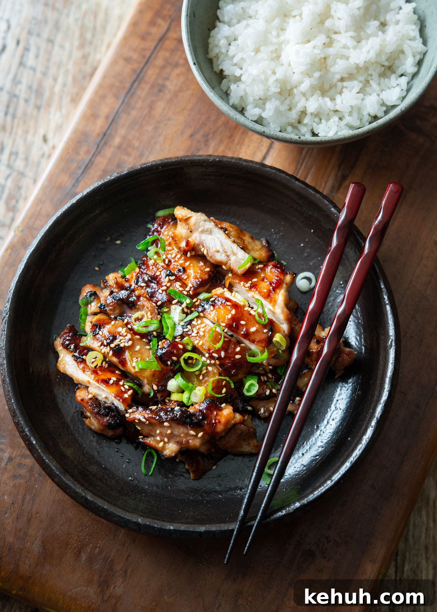 Miso chicken thighs plated with rice on the side