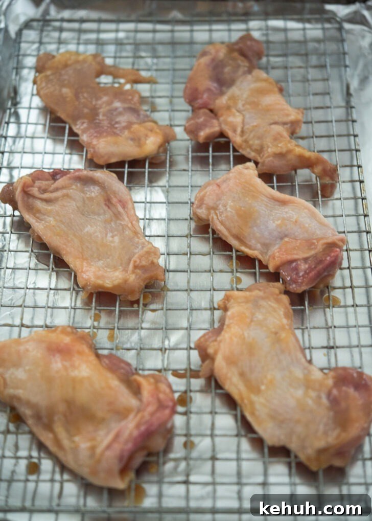 Miso-marinated chicken thighs on a rack over a sheet pan