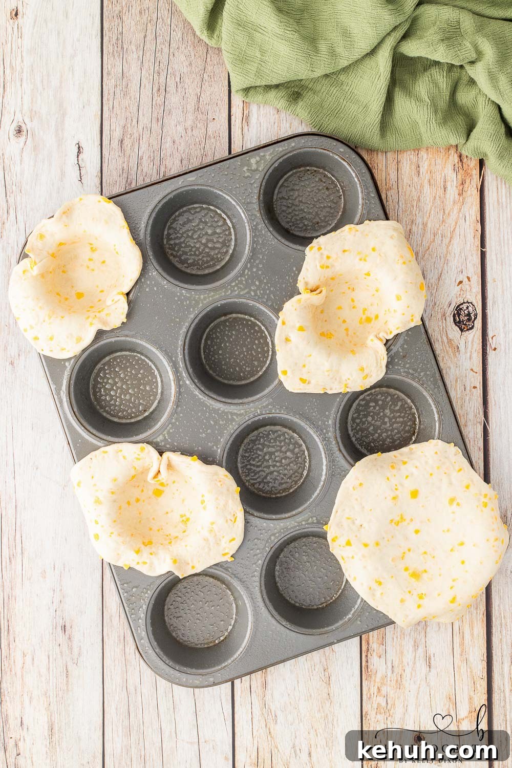 Spicy Chili-Stuffed Dinner Rolls: Savory Bite-Sized Appetizers 5 Placed rolled out biscuits into muffin tin
