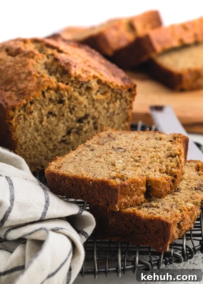 slices of sour cream banana bread on on a black wire cooling rack