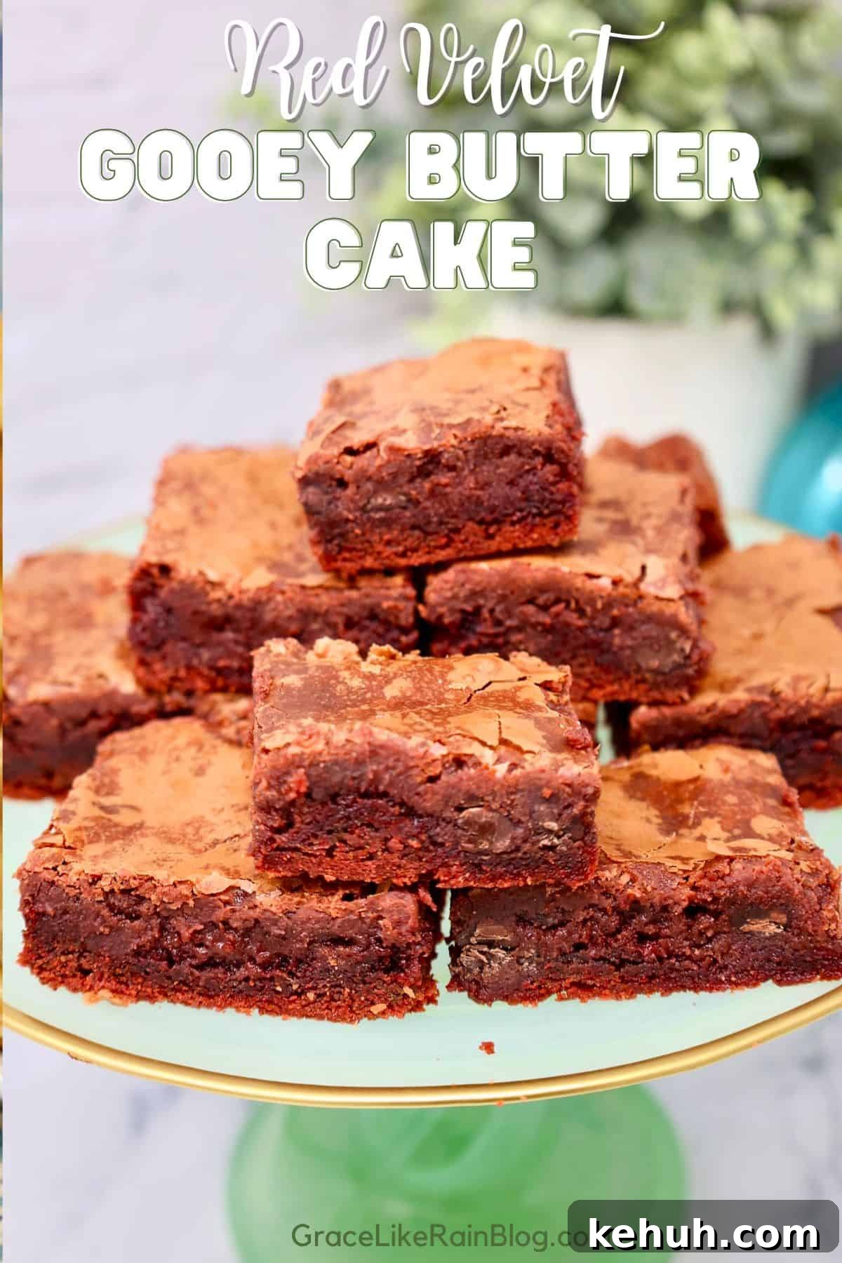 red velvet gooey butter cake bars dusted with powdered sugar in a glass baking dish