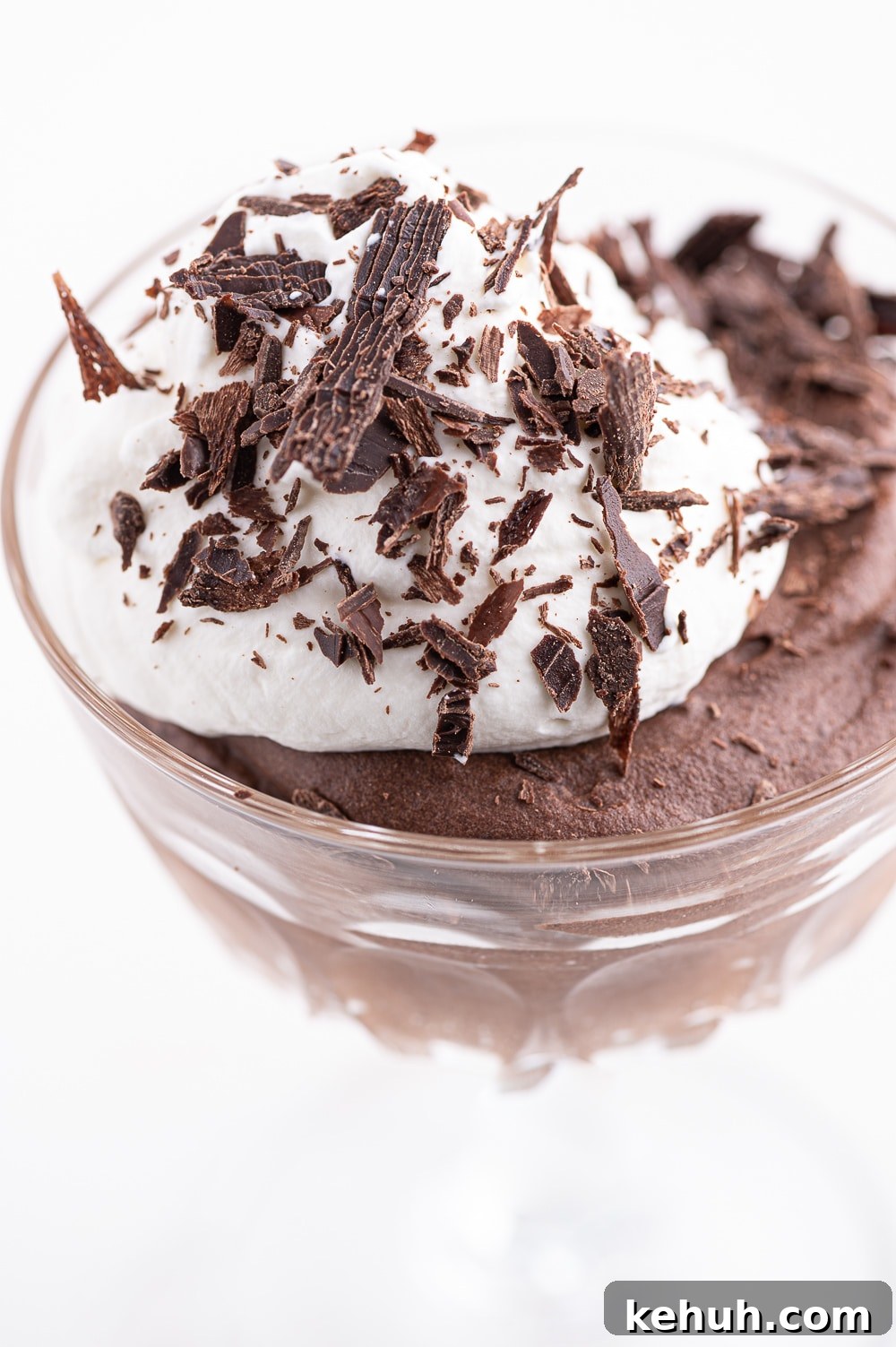 Keto Chocolate Mousse Recipe Without Eggs — Silky & Low-Carb 13 Sugar-free chocolate mousse in a glass dish with a dollop of whipped cream and dark chocolate shavings.