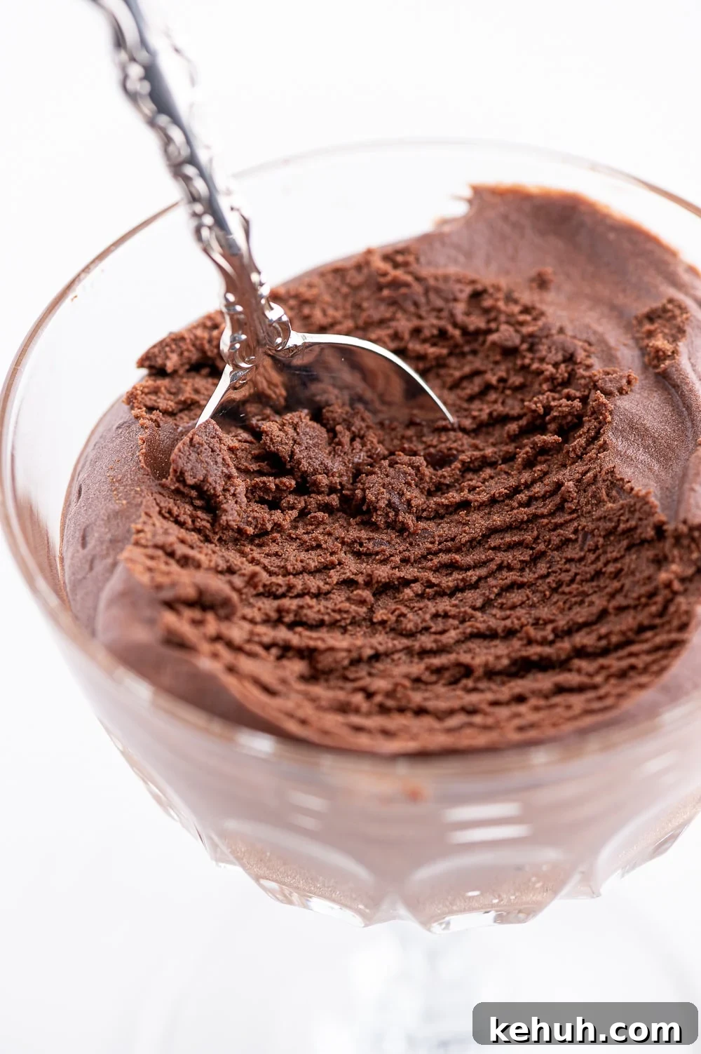 Keto Chocolate Mousse Recipe Without Eggs — Silky & Low-Carb 14 A dish of dark chocolate low carb mousse with a scoop removed to show the interior texture.