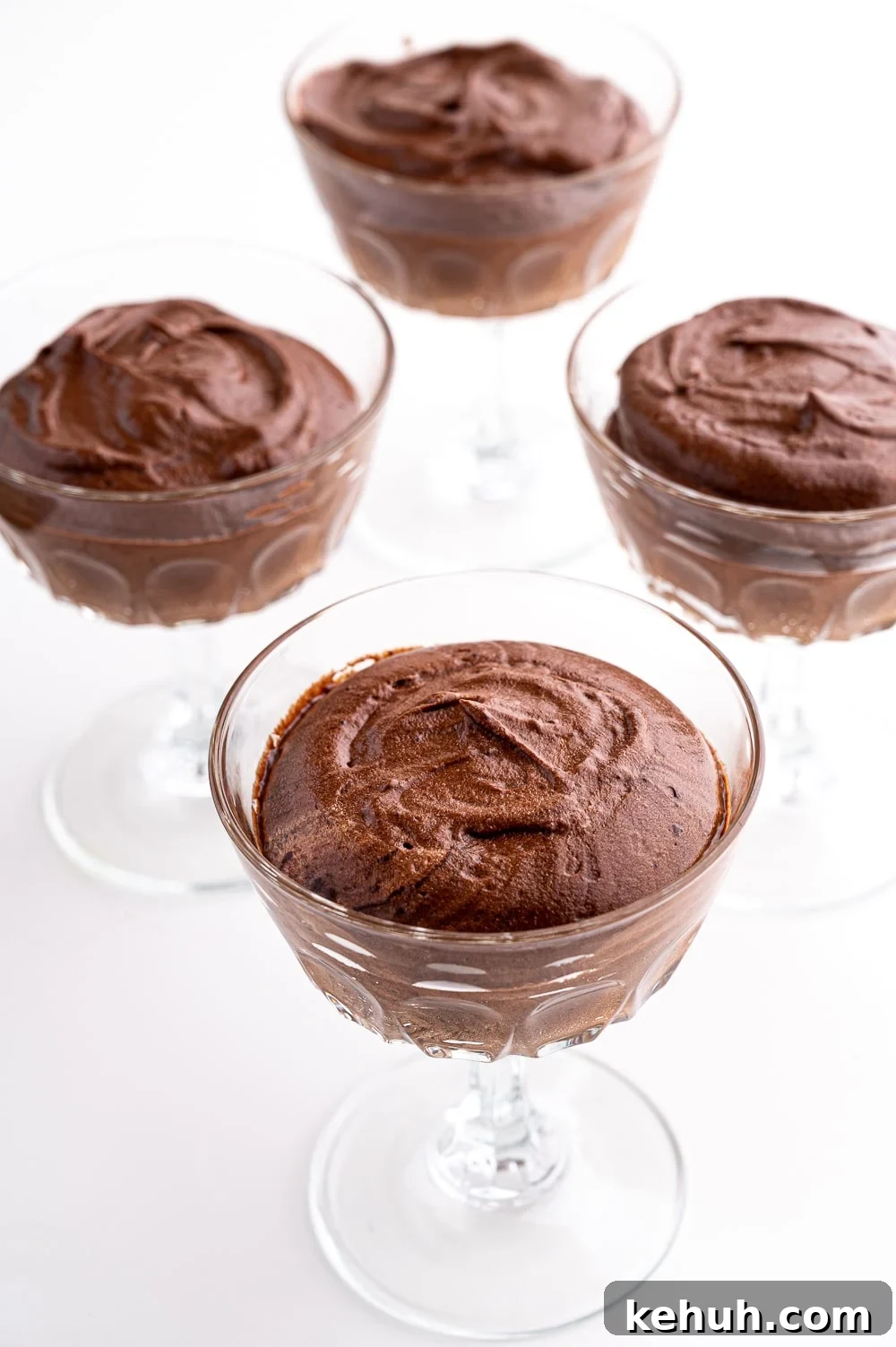 Keto Chocolate Mousse Recipe Without Eggs — Silky & Low-Carb 15 4 dishes of chocolate mousse against a bright white background.