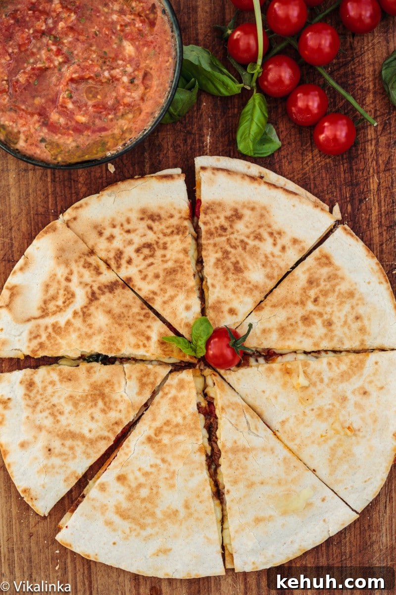 Italian Beef & Roasted Red Pepper Quesadilla Recipe 2 top down view of quesadilla and salsa in a bowl