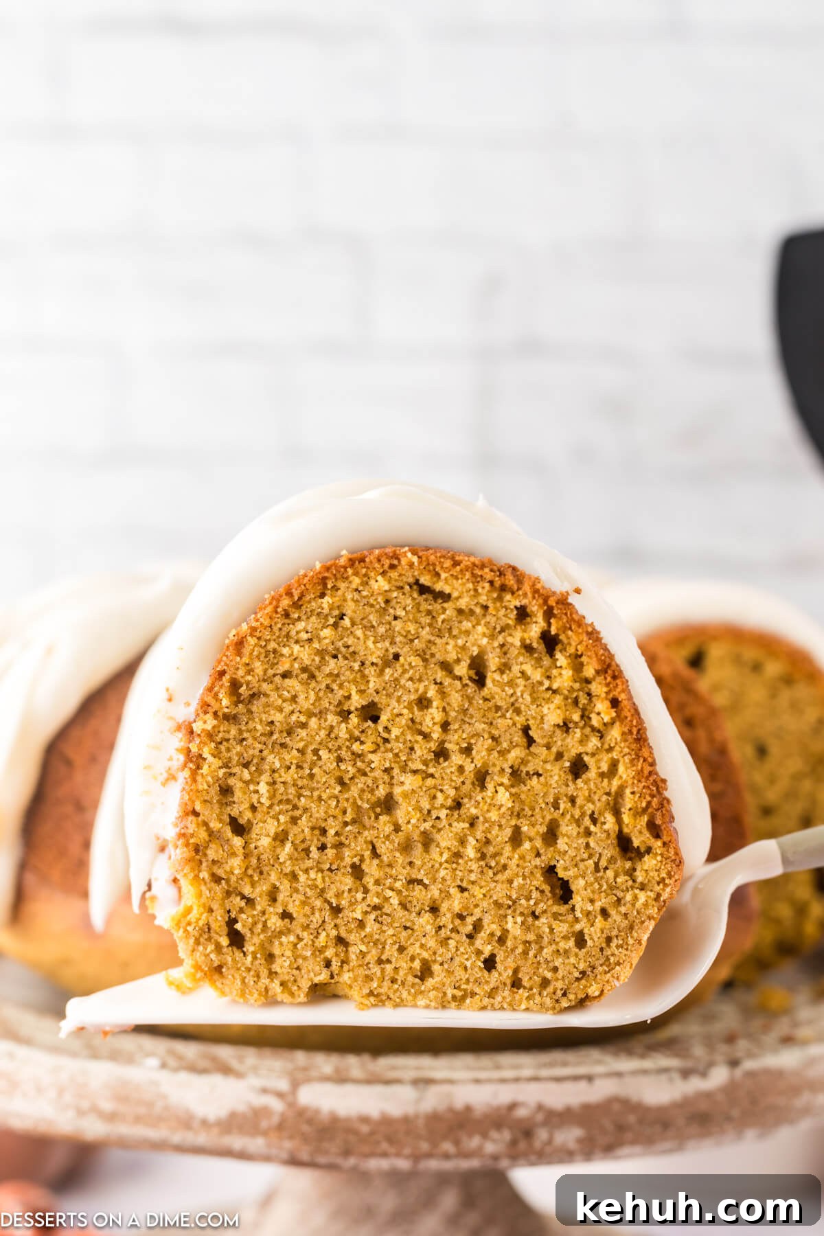 Moist Pumpkin Bundt Cake with Spiced Glaze 14 Pumpkin Bundt Cake being sliced.