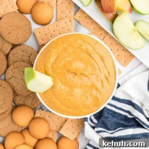 Moist Pumpkin Bundt Cake with Spiced Glaze 18 Pumpkin dip in a bowl surrounded with cookies and fruit on a tray.