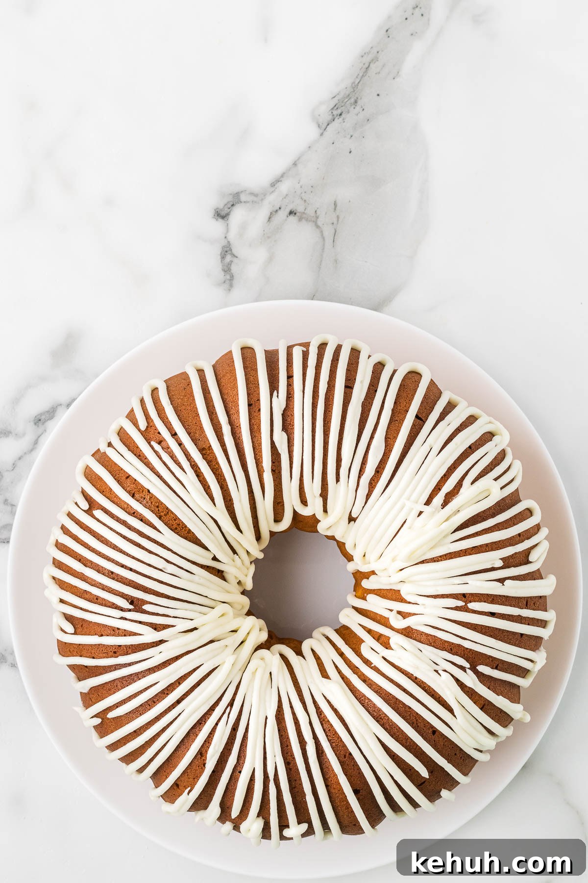 Moist Pumpkin Bundt Cake with Spiced Glaze 10 Icing piped on to cooled Pumpkin Cake.