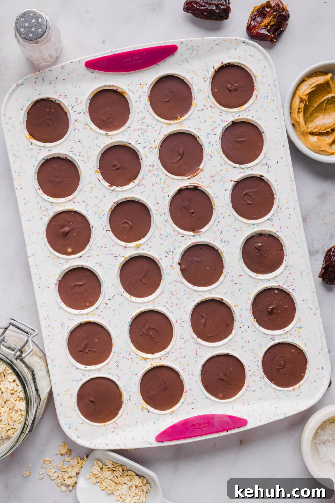 Healthy Twix bites set in a mini silicone muffin pan.
