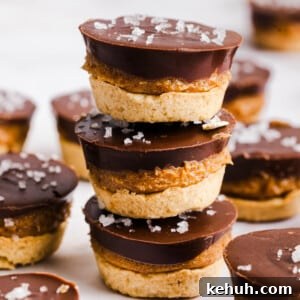 Three Twix bites stacked on a countertop.
