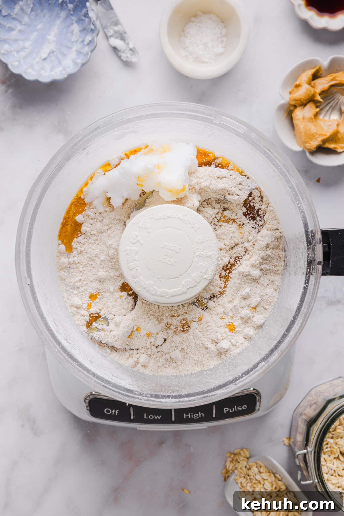Oat flour, coconut oil and maple syrup in a food processor.