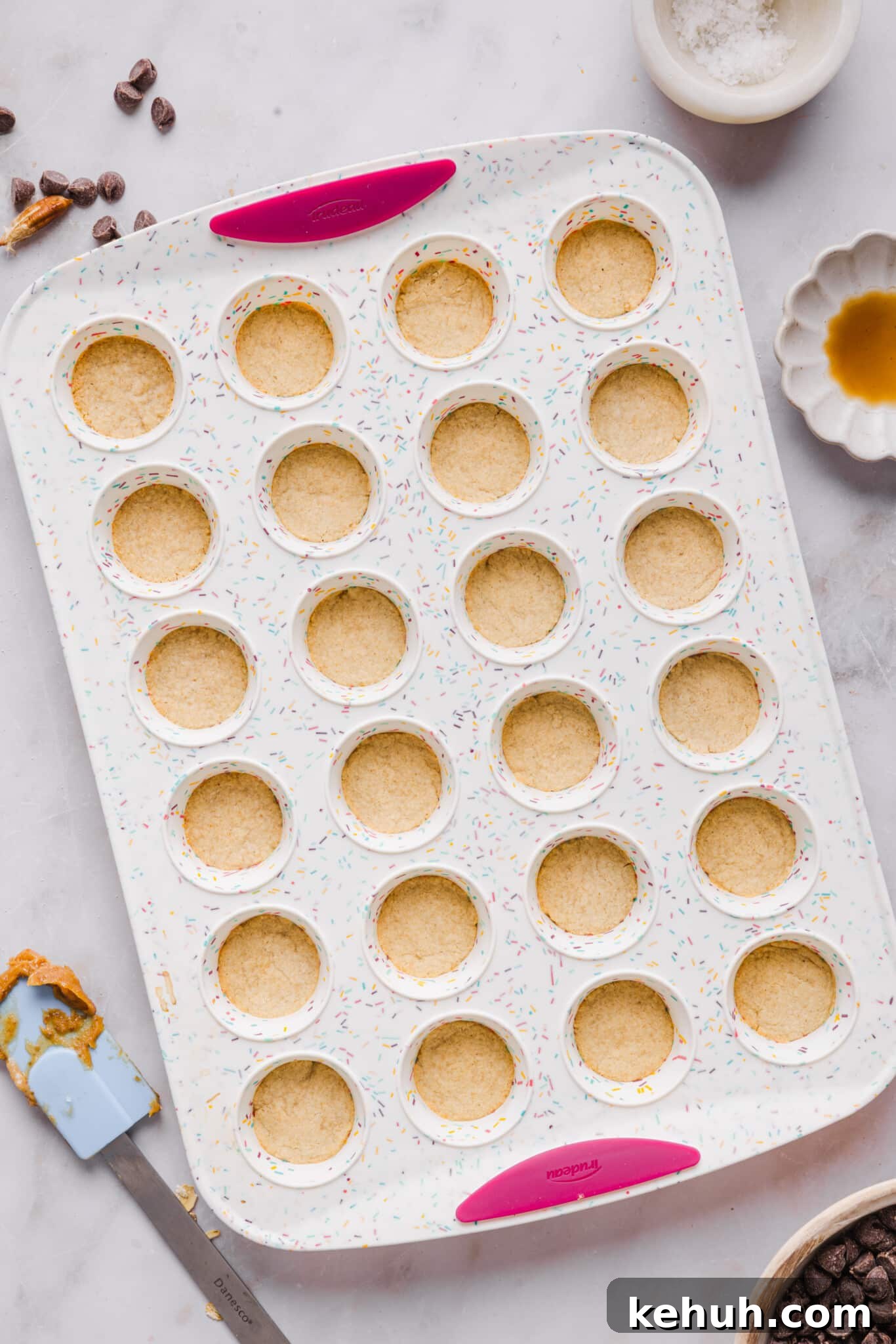 Healthy twix bites shortbread baked in a mini muffin pan.